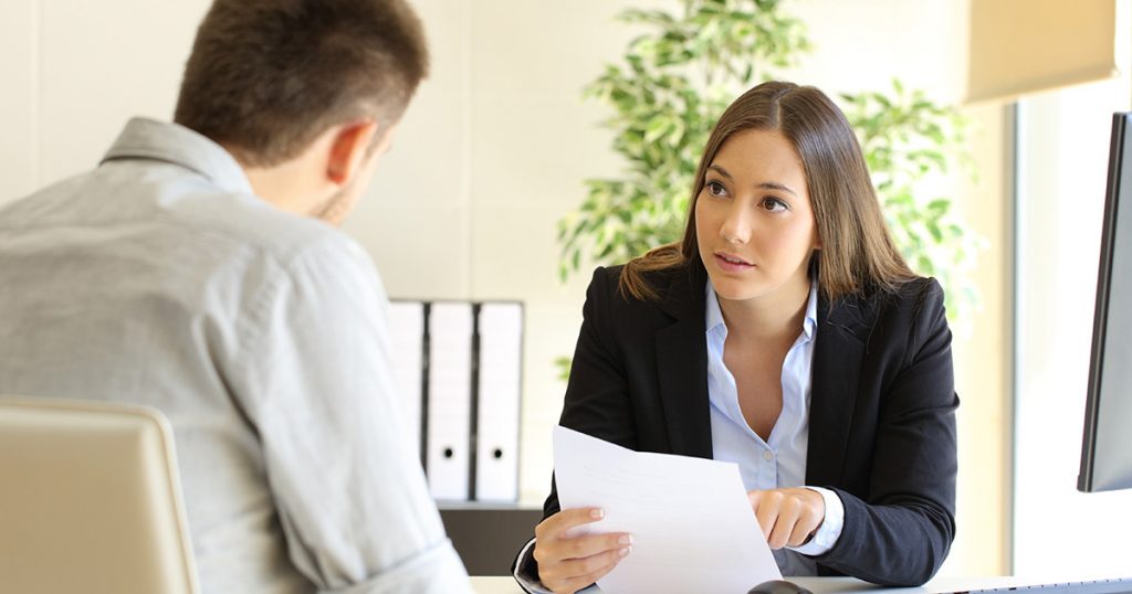 Foto Mann und Frau am Schreibtisch im Gespräch